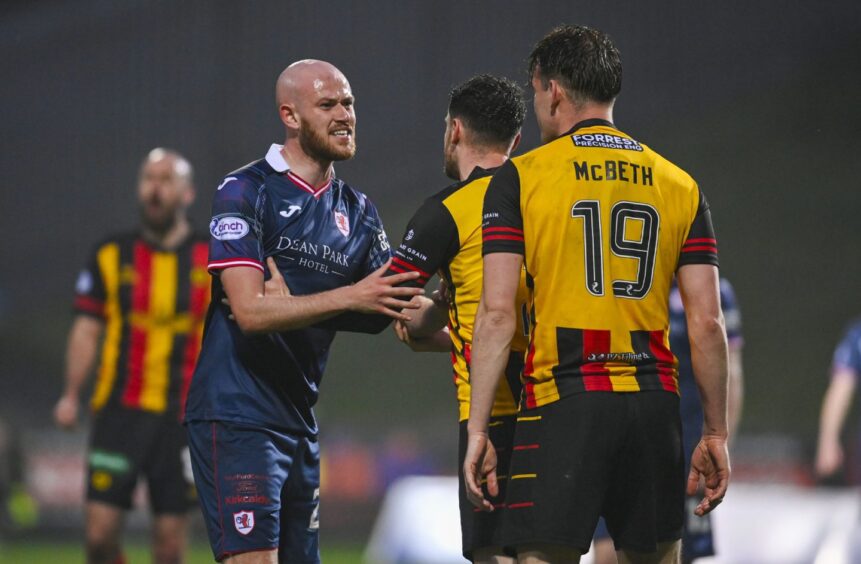 Raith Rovers' Zak Rudden exchanges words with Partick Thistle's Luke McBeth.