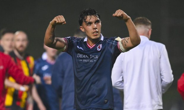 Raith Rovers defender Dylan Corr flexes his arm muscles.