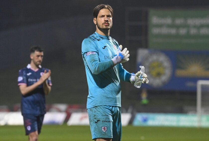 Kevin Dabrowski pats his chest with his right hand as he looks towards the Raith Rovers supporters at full-time.