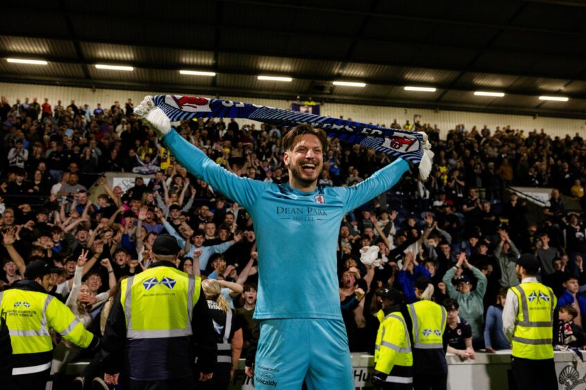 Goalkeeper Kevin Dabrowski holds up a Raith Rovers scarf after the win against Partick Thistle.