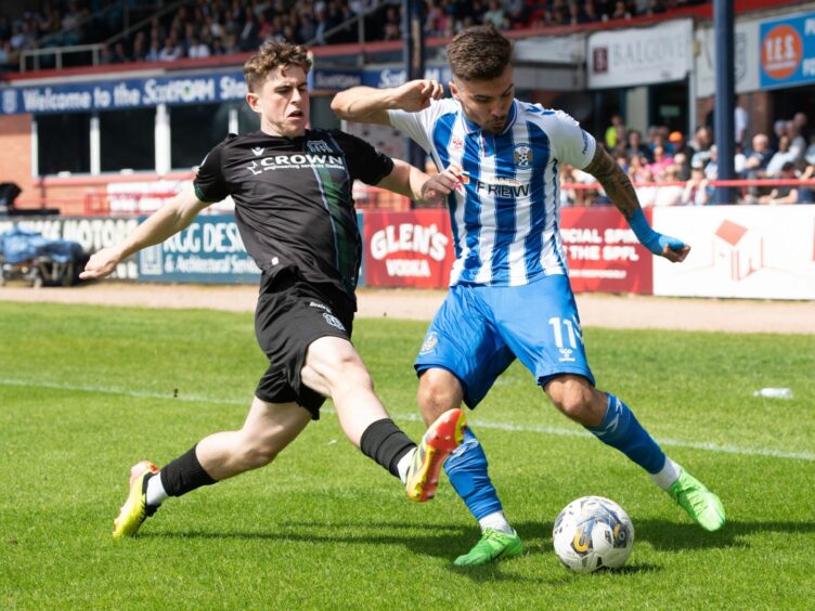 Fin Robertson blocks a Dan Armstrong cross as Dundee drew with Kilmarnock. Image: SNS