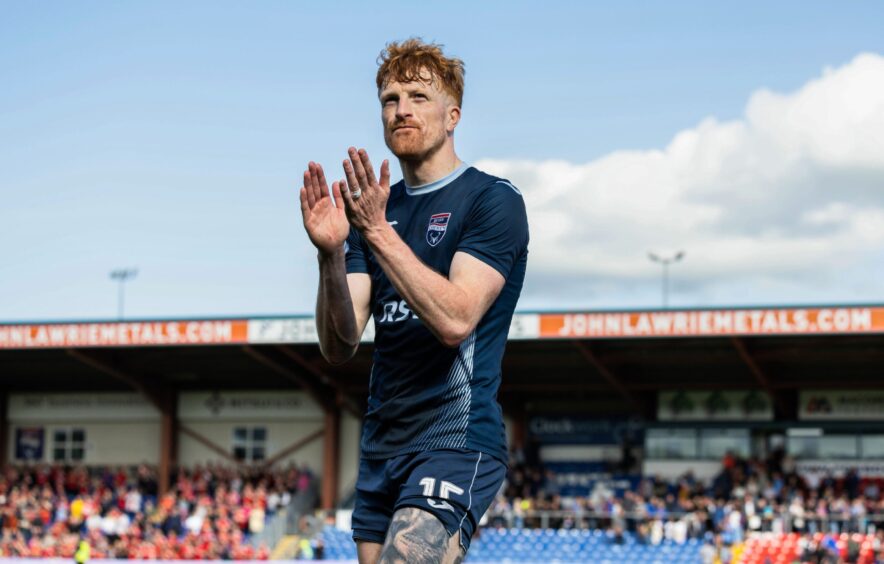 Ross County striker Simon Murray claps his hands.