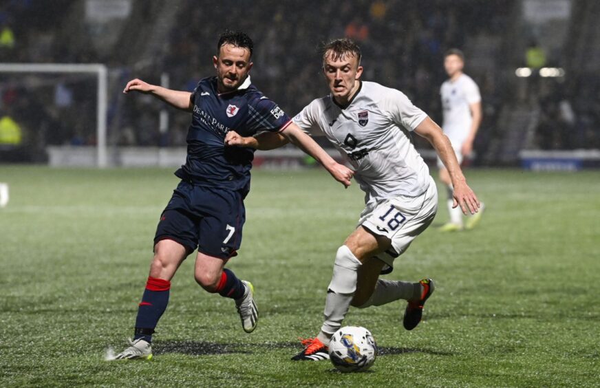 Raith Rovers winger Aidan Connolly tussles for the ball with Ross County's Eli King.