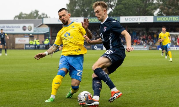 Raith Rovers' Dylan Easton tackles Ross County's Eli King.