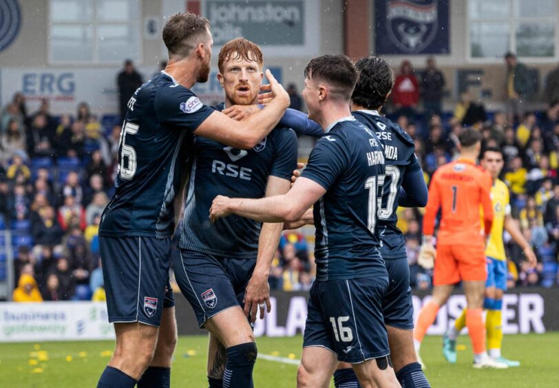 Simon Murray is congratulated by his team-mates after scoring for Ross County.