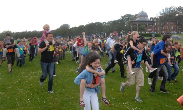 People take part in the piggyback world record attempt in 2011.