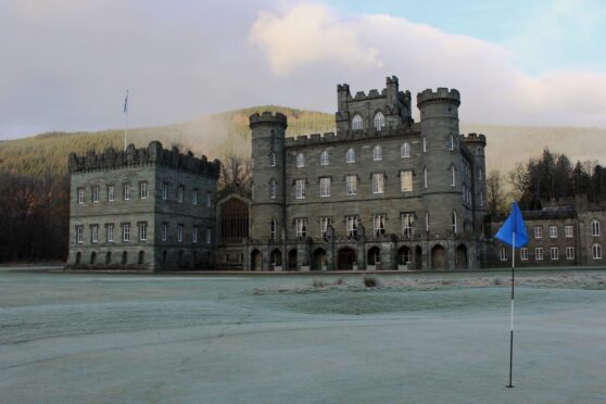 Taymouth Castle with golf flag in foreground