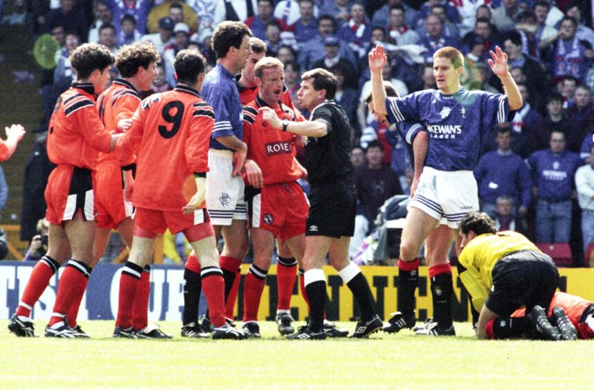 Dundee United players appeal for a penalty after Alec Cleland is bundled over against Rangers in 1994