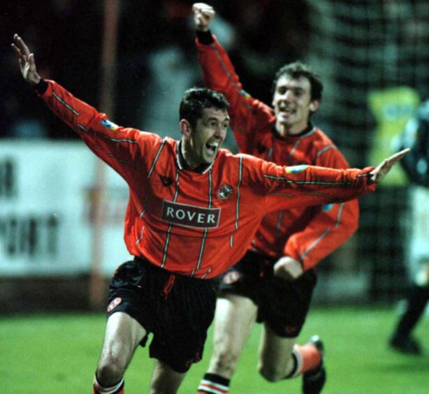 A delighted Owen Coyle wheels away after his 115th-minute winner, pursued by Christian Dailly