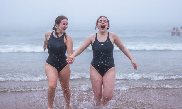 Pictures as St Andrews students brave chilly and misty waters for annual May Day dip