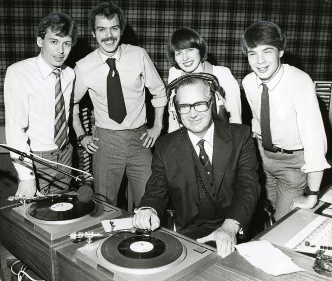 Tony Donald, Gerry Quinn, Norma Gamble and Graham Stuart with Lord Thomson, who is putting on a record