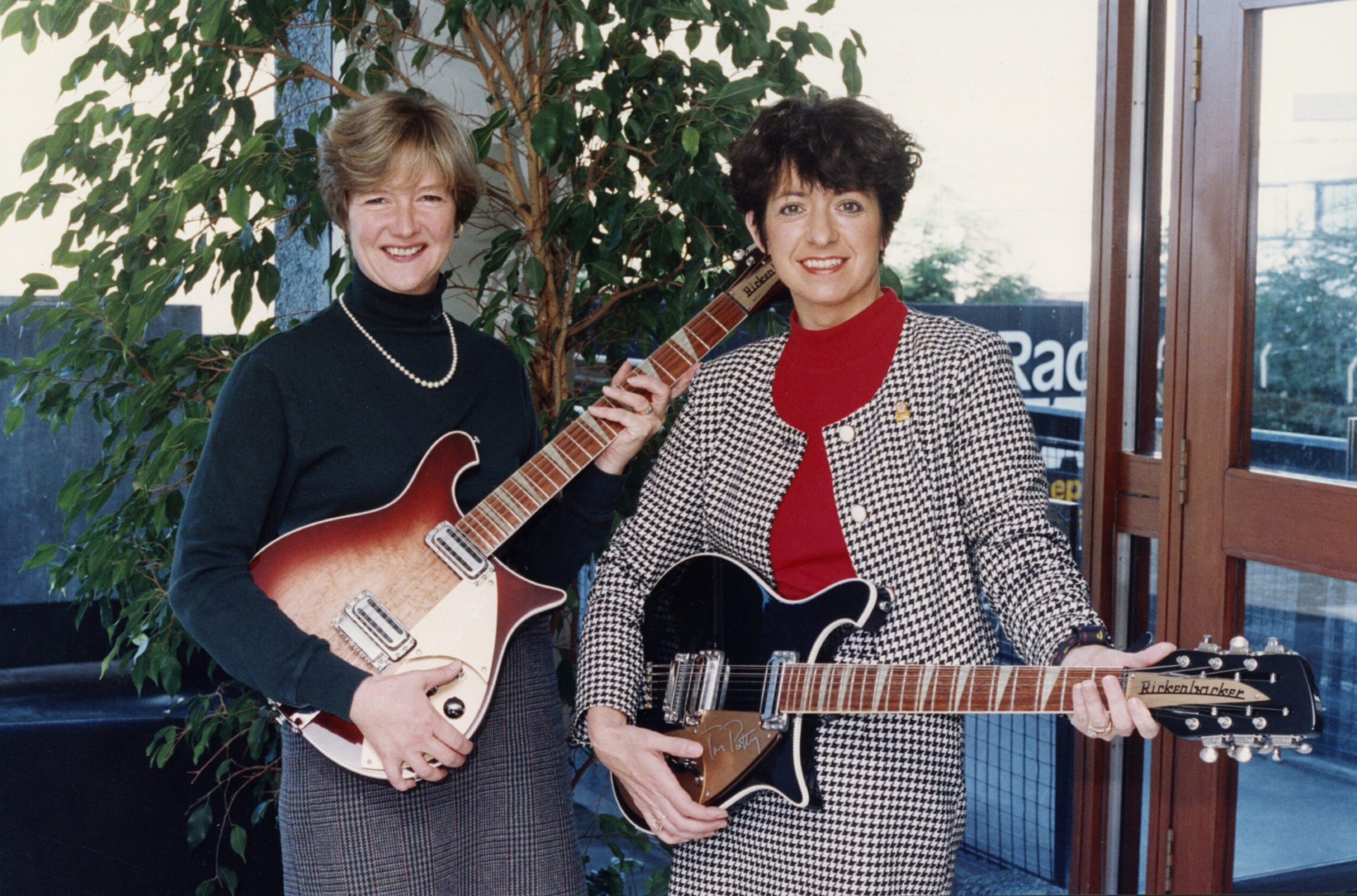 Anne Clarke and Lorraine Stevenson of Radio Tay with signed Tom Petty guitars for Caring for Kids in 1993.