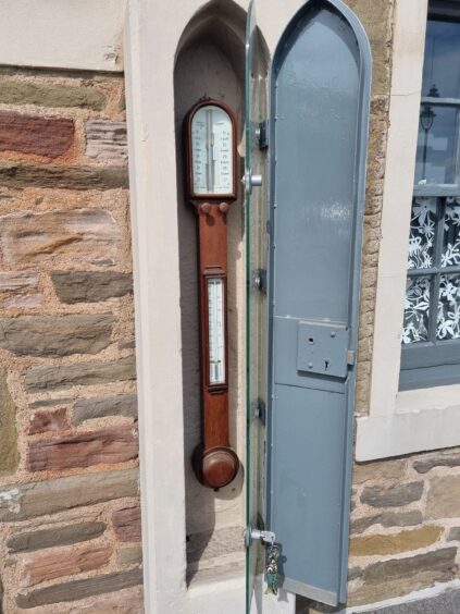 The barometer sits in a stone case beside the front door of the Broughty Ferry cottage.