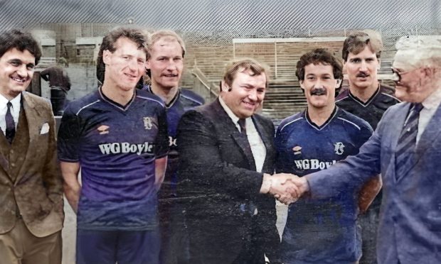 Billy Boyle shaking hands over the Dundee FC strip