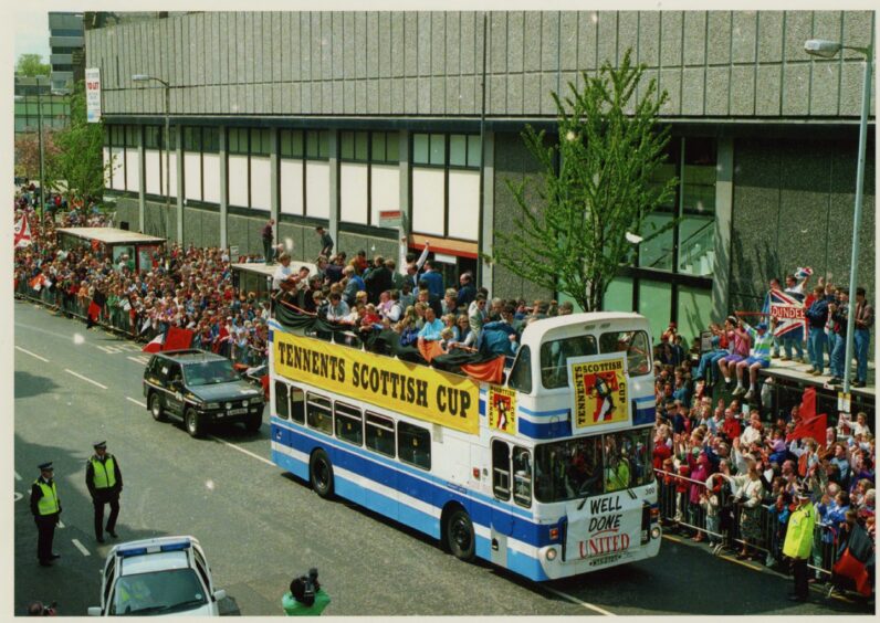 The Dundee United bus passes celebrating fans after winning the 1994 Scottish Cup