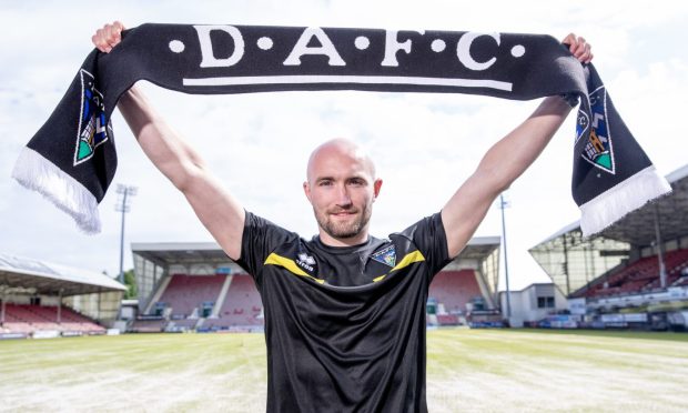 Chris Kane holds up a Dunfermline scarf at East End Park.