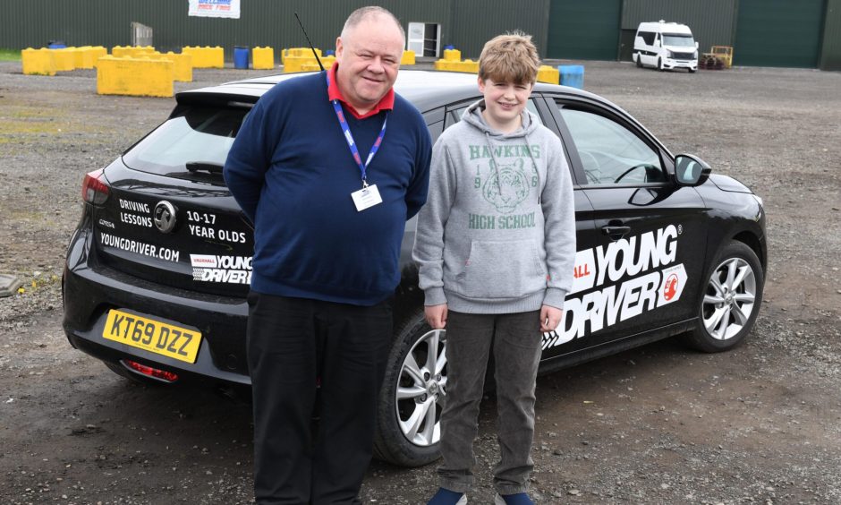 Alex with his driving instructor Stuart Kivlin.