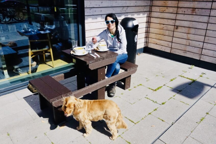 Gayle is joined by a customer's friendly dog at the Larick Centre cafe.