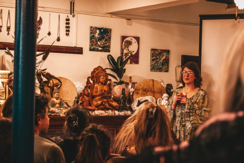 Lhamo Grace speaking to room full of people in Crieff crystal shop