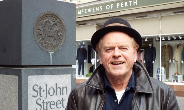 Alan Gorrie of the Average White Band in St John Street, Perth, outside McEwens of Perth.