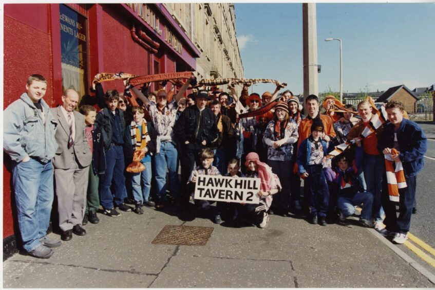 Dundee United fans gather outside Hawkhill Tavern before heading to Glasgow.