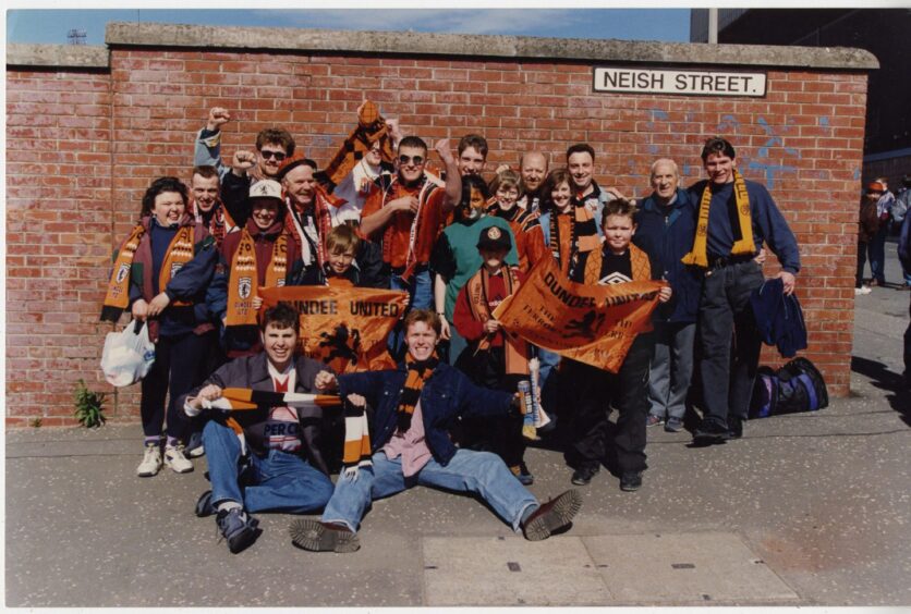 Dundee United supporters waving flags leaving from Tannadice to attend the 1994 Scottish Cup final.