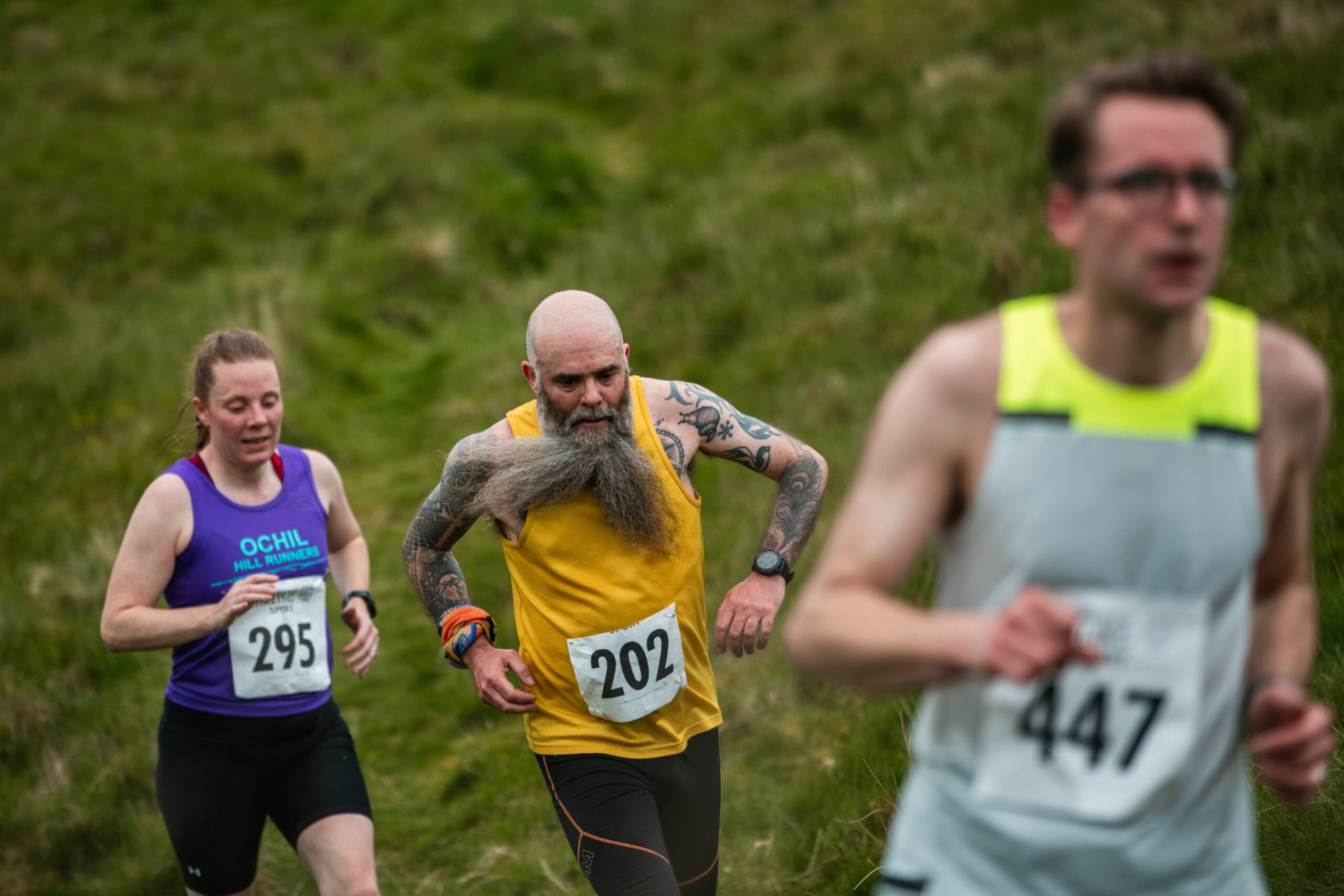 Three runners during the Dumyat Hill Race