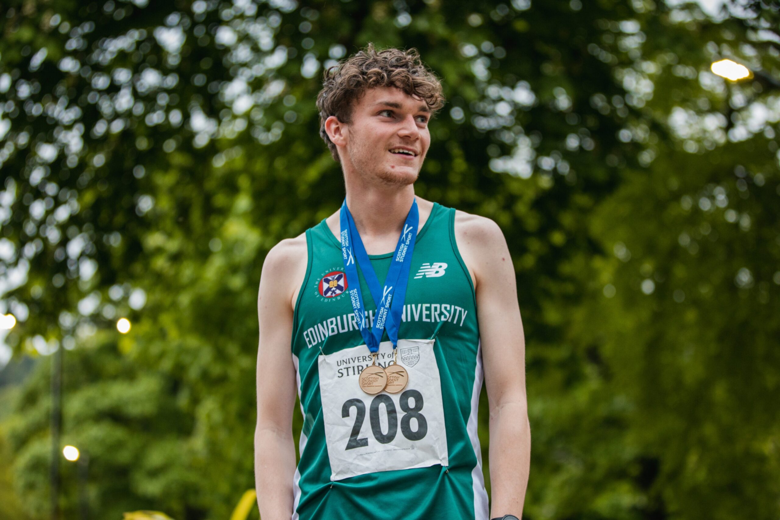 Race winner, Matt Knowles stands with his medals around his neck after the race.