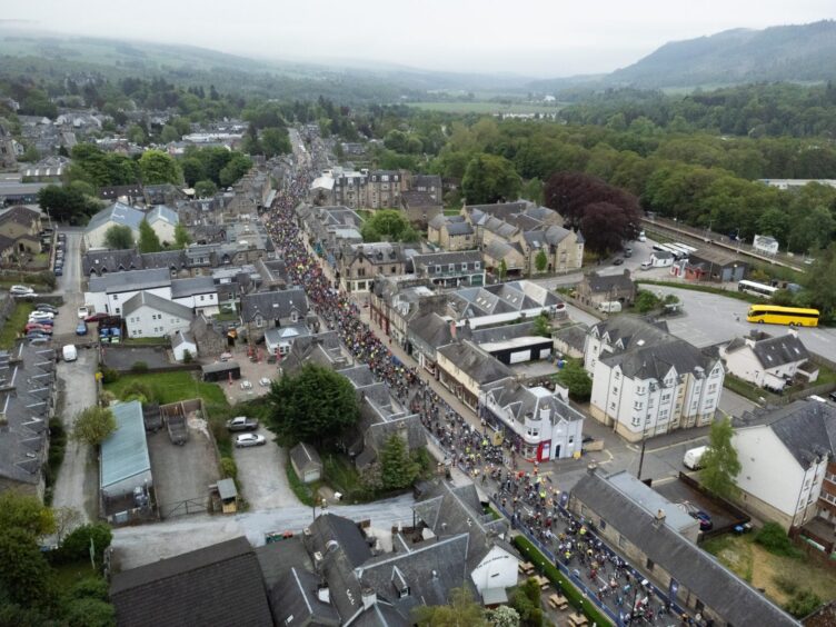 Aerial photo showing streets of Pitlochry filled with cyclists