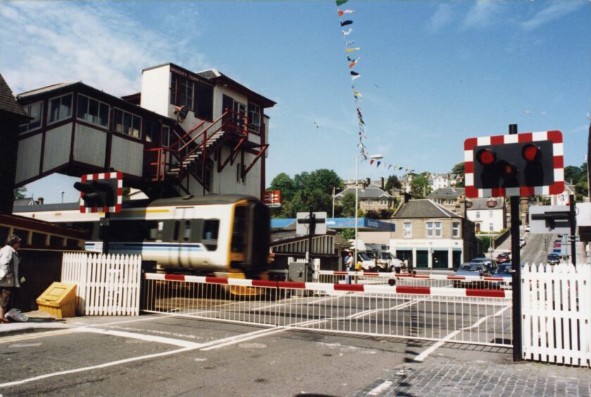 A train driving through the level crossing in Broughty Ferry
