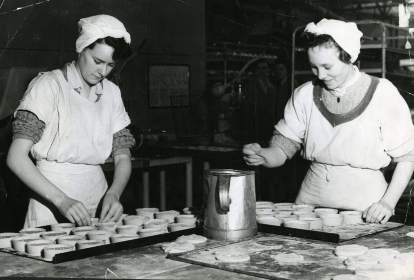 Staff filling meat pies at the Kings Cross Road bakery of William Beattie. 