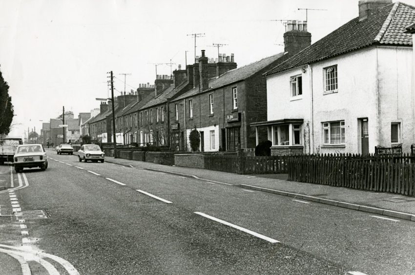Invergowrie Main Street in April 1978, with three shops at the end of a row of houses