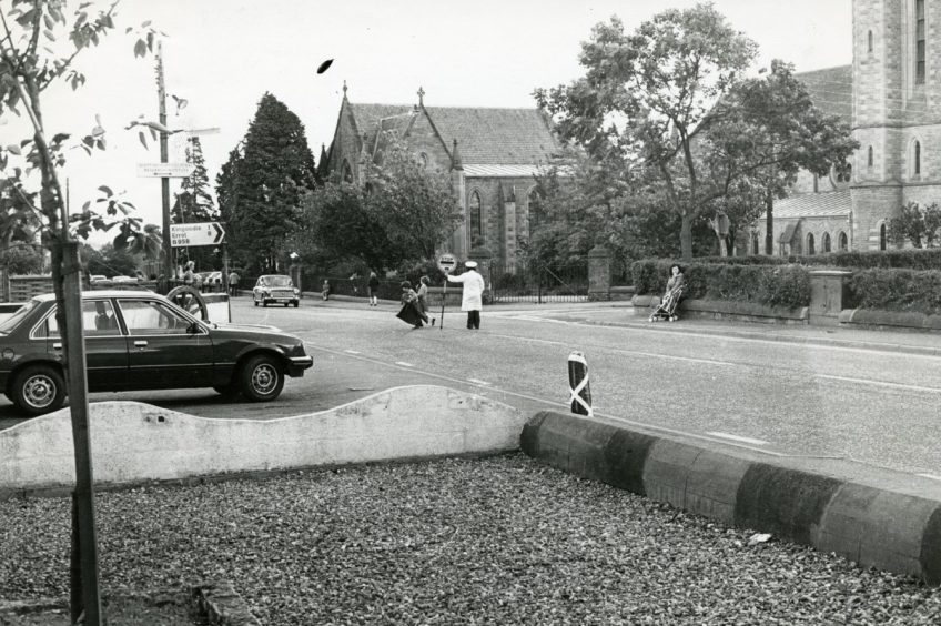 A view of Invergowrie from September 1977, taken from outside the Invergowrie Inn, and looking across Main Street at the Errol Road junction.
