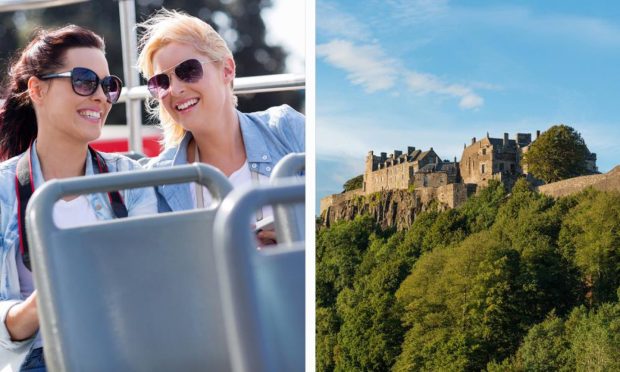Tourists on an open top bus and Stirling Castle.