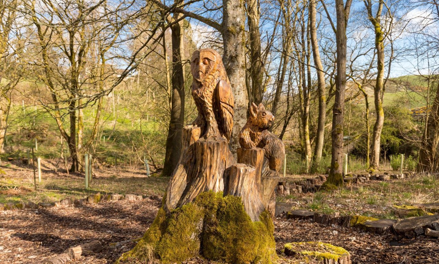 Carved animals keep watch over the woodland. 