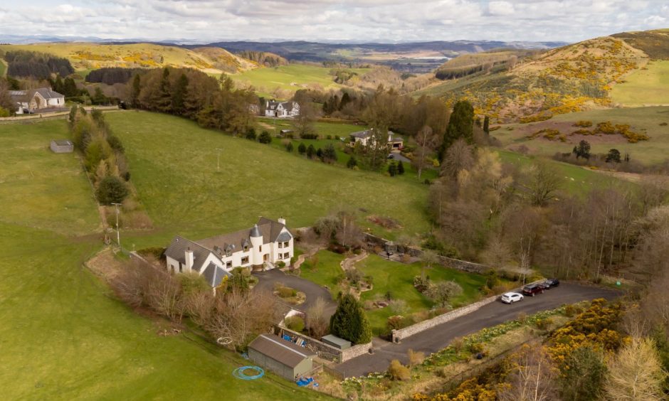 An aerial view of Highfield House, with hills in the distance.