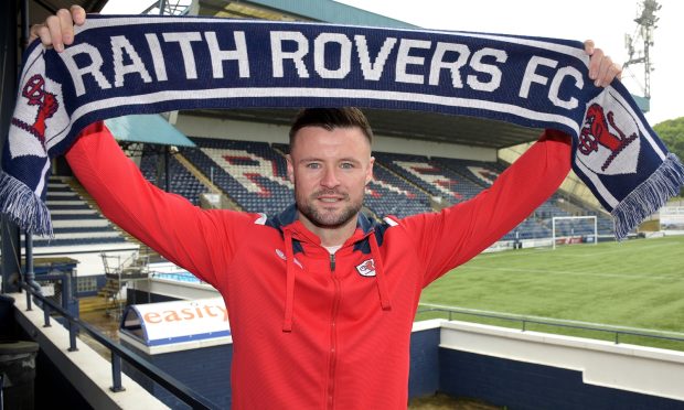 New signing Callum Fordyce holds up a Raith Rovers scarf.