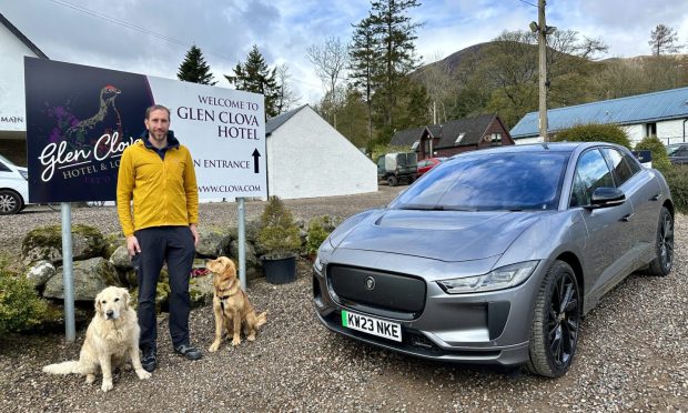 Motoring writer Jack McKeown and his two dogs beside the Jaguar I-Pace
