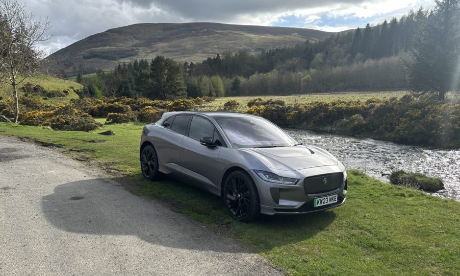 The Jaguar I-Pace parked beside a river on the way from Innerleithen to Dundee. 