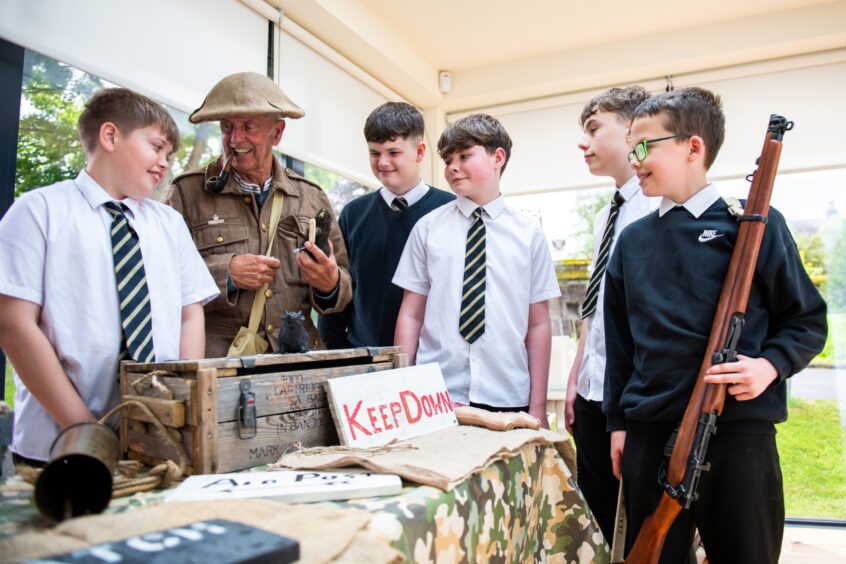 Group of pupils with soldier dressed in WWI gear