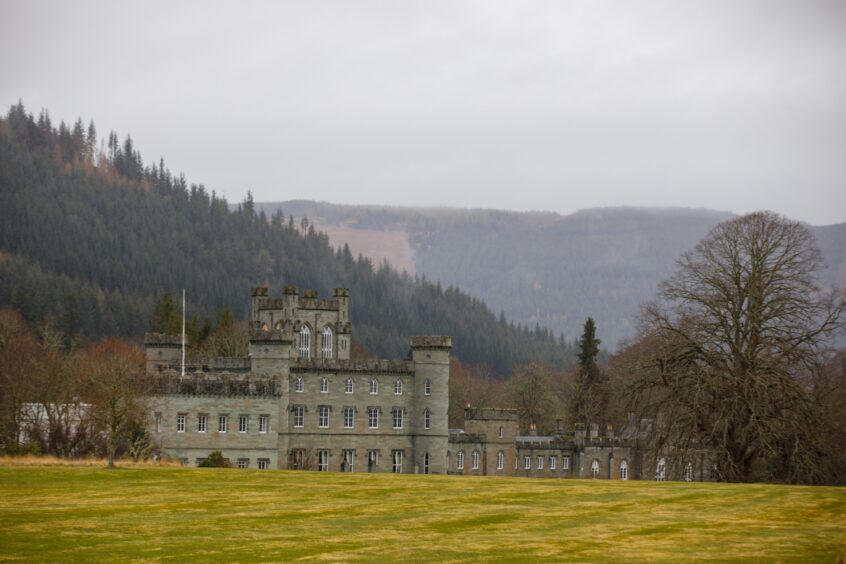 Taymouth Castle with mountains and forests behind