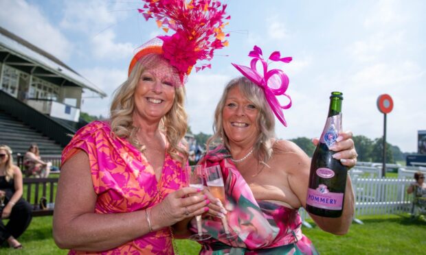 CR0048253, Kieran Webster, Perth. Perth Ladies Day. Picture shows; Perth Ladies day at Perth Races
Sheila morris and Susan Neilson from Milnathort crack open the bubbles
Thursday 16th May 2024. Image: Kenny Smith/DC Thomson