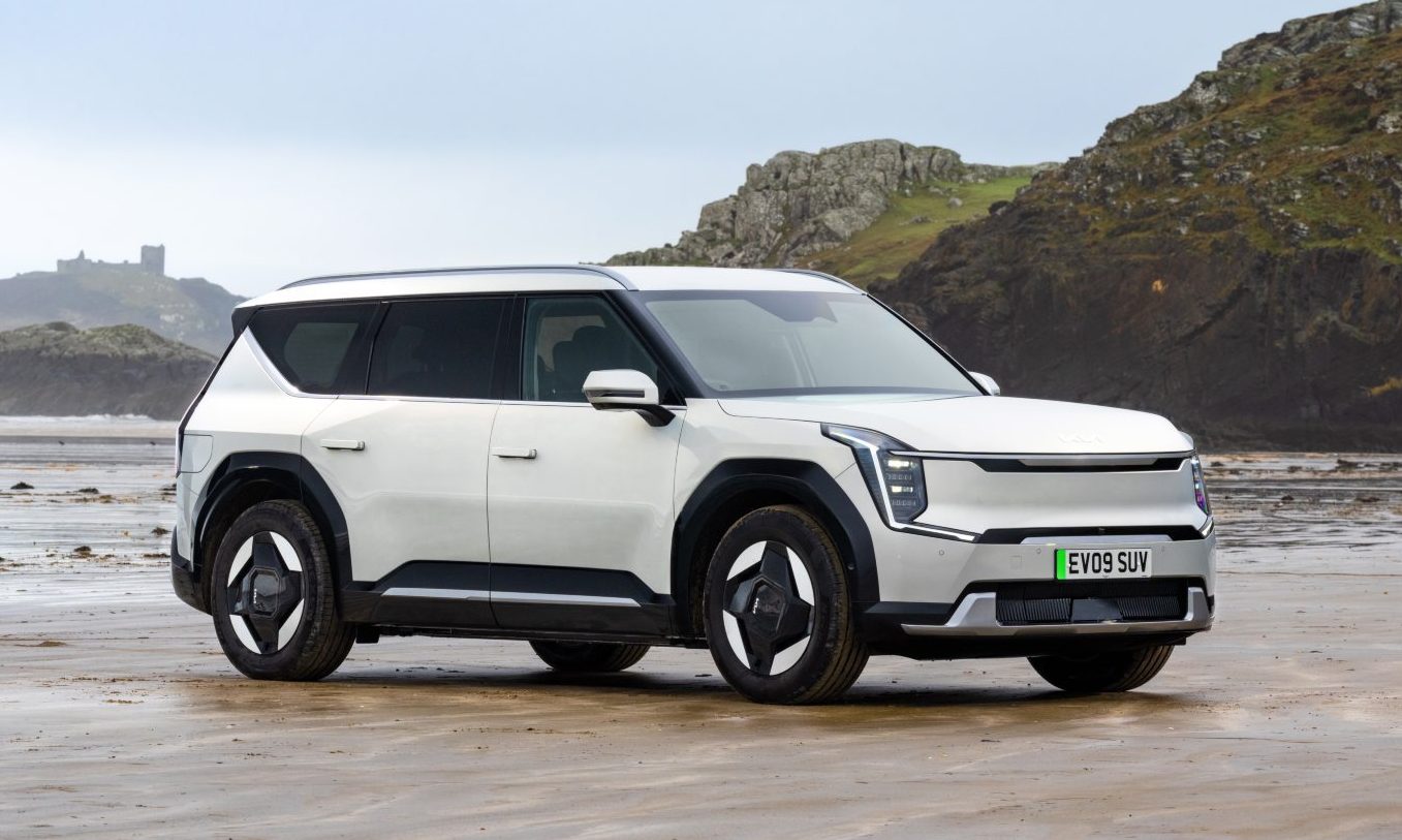 A white Kia EV9 on a beach