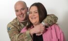 Andy and Lynne Warren hugging, as they describe family life in the army at Leuchars.