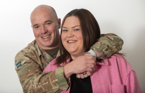 Andy and Lynne Warren hugging, as they describe family life in the army at Leuchars.