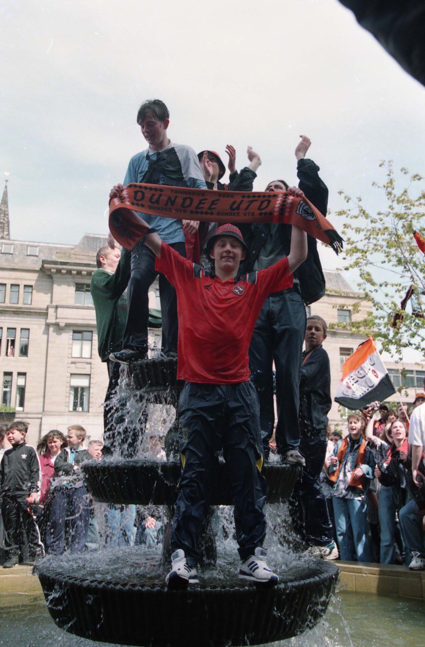 Fans celebrating in the City Square fountains. 