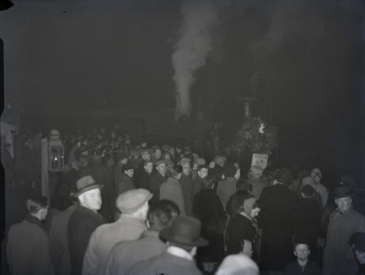 A crowd swamp the platform at Barnhill Railway Station as the last train arrives in 1955.