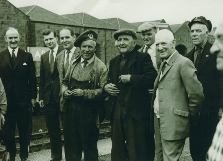 Ian Fraser with his Railway Home Guard bonnet on with enthusiasts in 1964.