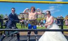 Couple Andrew and Robyn Petersen in the wrestling ring on their wedding day.