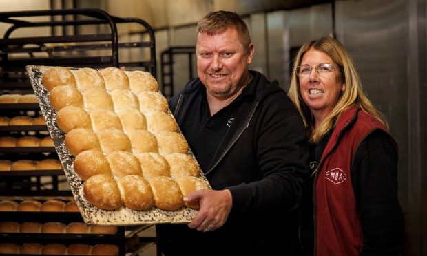 You gotta roll with it. Murdoch Allan owners Paul and Katrina Allan with the new Dundee roll. Image: Murdoch Allan